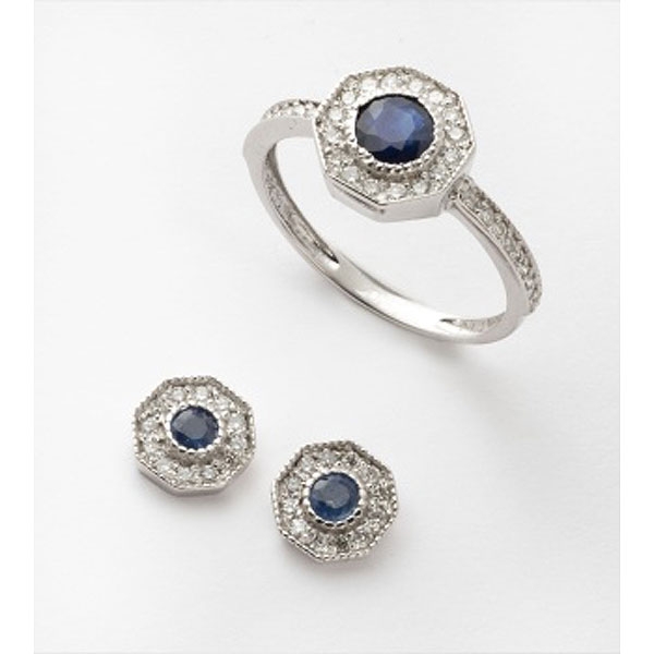 Conjunto de sortija y pendientes en oro blanco con zafiro azul central y orla de diamantes talla brillante.