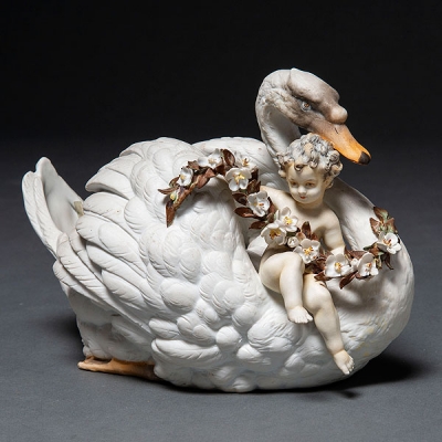 Centro de mesa en forma de cisne portando un niño con guirnalda de flores en porcelana francesa del siglo XIX