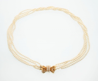 Gargantilla de 4 filas de perlas cultivadas con cierre en oro amarillo en forma de lazo con 2 filas de perlas  y diamantes talla brillante.