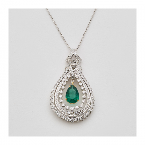 Colgante diseño lágrima calada en oro bicolor con esmeralda de Zambia talla perilla y bandas de diamantes talla brillante