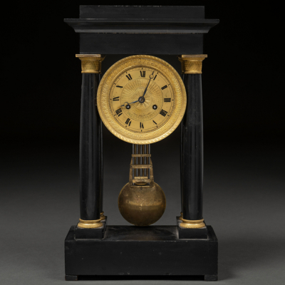 Reloj de pórtico de sobremesa Napoleón III en mármol negro con esfera en y capiteles en bronce dorado. Trabajo Francés del siglo XIX