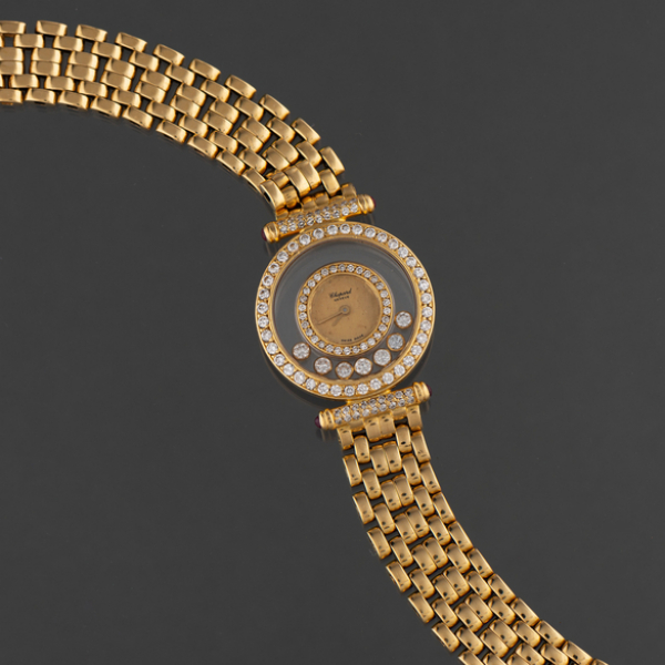 CHOPARD, Geneve, Reloj de Dama en oro amarillo de 18 kt con doble orla de brillantes y 7 brillantes al interior.