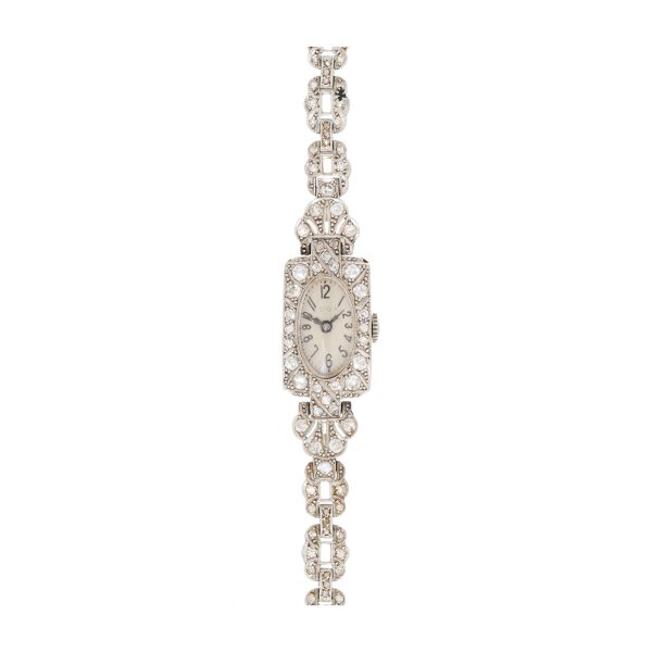 Reloj Art Deco «Dox»de pulsera para señora. En platino c.1930. Armis y bisel cuajados de diamantes tallas brillante antigua y 8/8.