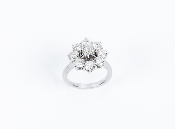 Sortija rosetón en oro blanco, con centro y orla de limpios y blancos diamantes talla brillante