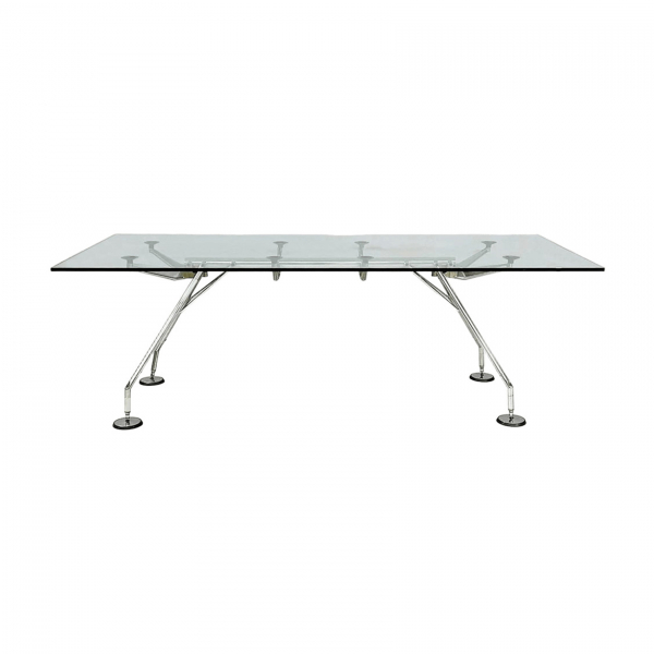 Norman Foster (Reddish, Reino Unido, 1935) para Tecno. Mesa modelo «NOMOS 220» con estructura esqueleto en metal y aluminio cromado. Sobre en cristal templado transparente apoyado directamente sobre ventosas acolchadas. Sellos de origen.