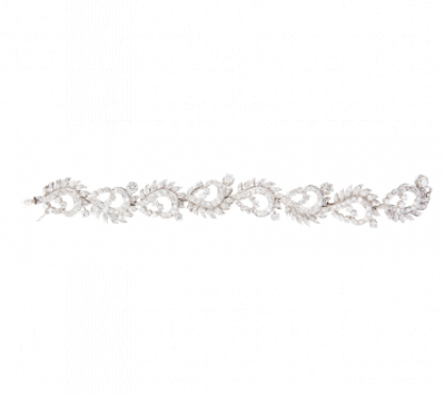 Brazalete años 50 con ocho centros de cintas onduladas decoradas con hojitas de brillantes, y brillantes en garras de mayor tamaño.   En oro blanco de 18K.