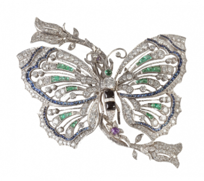 Broche con diseño de mariposa de estilo Art-Decó con brillantes, esmeraldas, ónix y zafiros calibrados. 