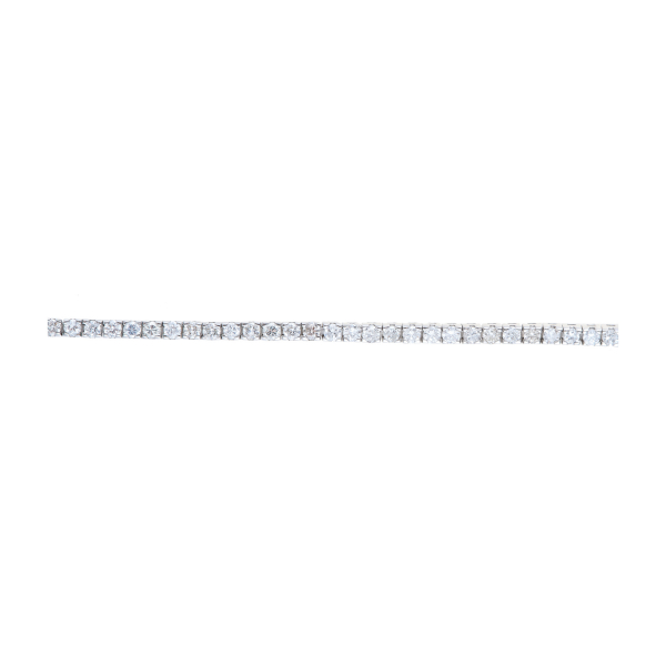 Pulsera rivière en oro blanco con diamantes talla brillante engastados en garras.