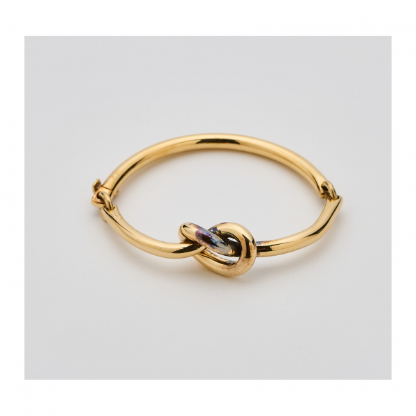 PUIG DORIA. Pulsera esclava articulada diseño nudo en oro. Firmada y numerada.