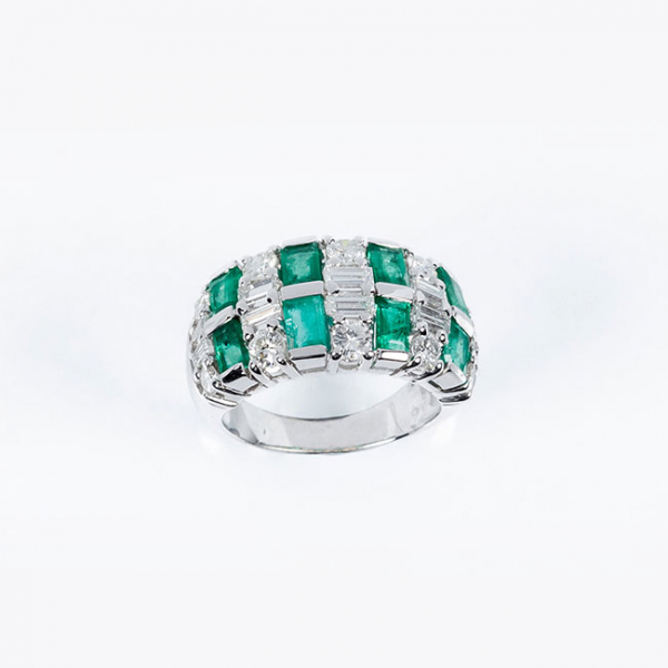 Sortija en sólida montura de oro blanco 18 K con limpios y blancos diamantes, talla brillante y baguette, y bonitas esmeraldas 