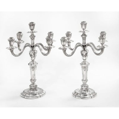Pareja de candelabros de 5 brazos en plata con decoración de guirnaldas, gallones y rocallas. Estilo Luis XVI. Marcas en la base. Au Monde Elegant. Bilbao.