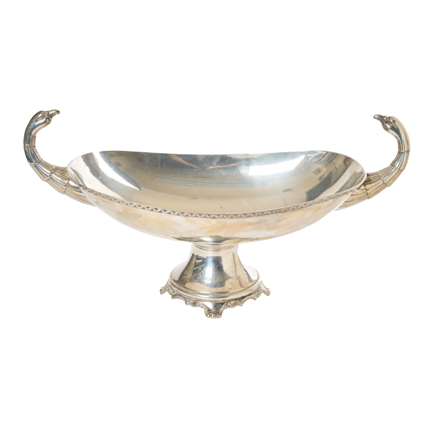 Centro de mesa en plata española punzonada de diseño oval con decoración perimetral con motivos geométricos y asas en forma de cabezas de cisne.