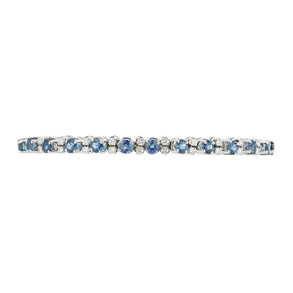 Pulsera rivière en oro blanco con zafiros azules talla redonda y pareja de diamante talla brillante alternados. 