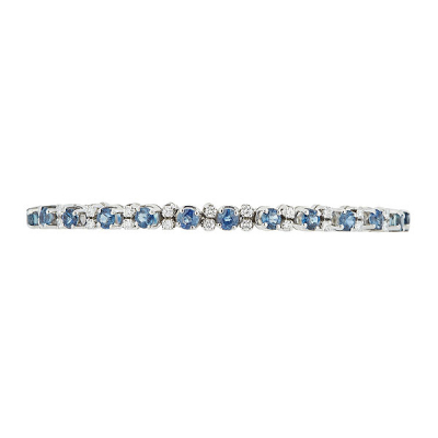 Pulsera rivière en oro blanco con zafiros azules talla redonda y pareja de diamante talla brillante alternados. 