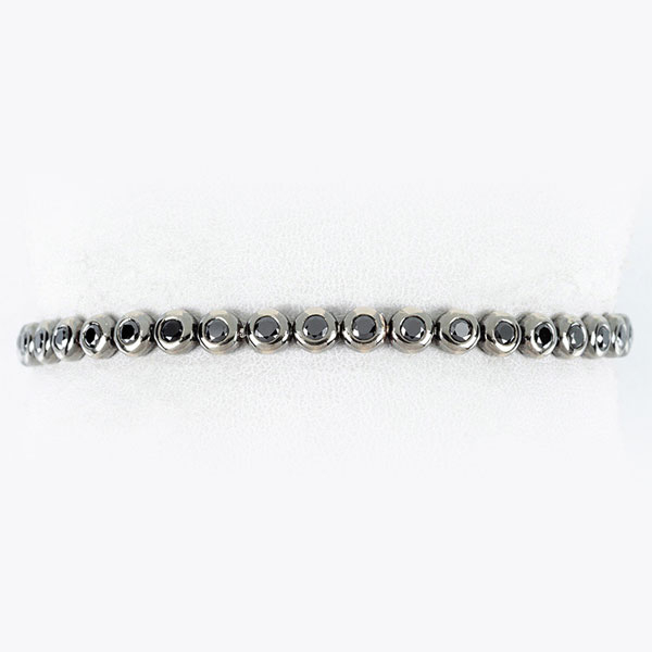 Pulsera riviere SUAREZ en sólida montura de oro blanco 18 K, pavonado, con fila articulada de diamantes negros 