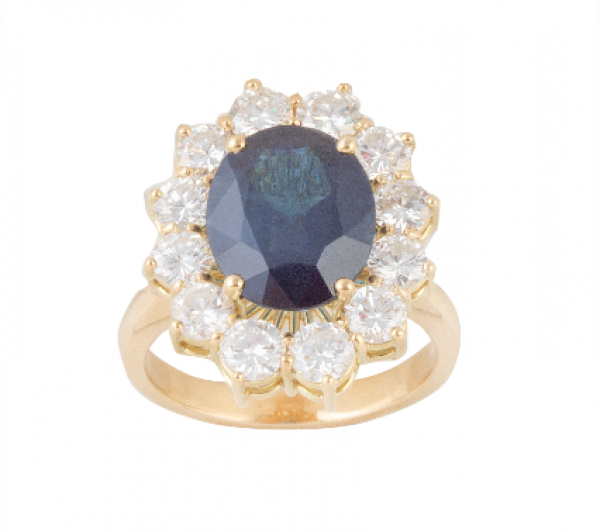 Sortija con zafiro oval de 6,33 ct. orlado de brillantes  En montura de oro amarillo de 18 K.