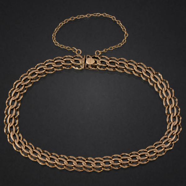 Pulsera de doble eslab&oacute;n barbado en oro amarillo de 18 kt.