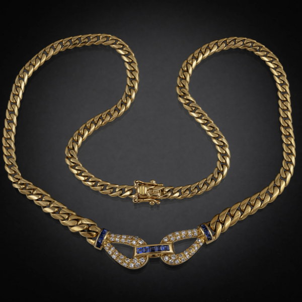 Gargantilla en oro amarillo de 18 kt con colgante en forma de lazo con brillantes y zafiros calibrados.