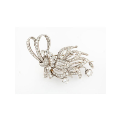 Broche en platino formando lazo con 9 diamantes talla brillante y con cuajado de diamantes talla brillante con un peso total de 2 cts. aprox.
