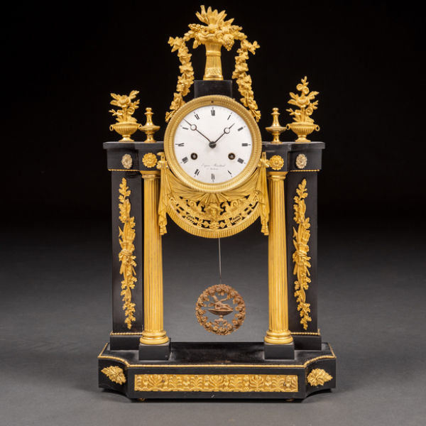 Reloj de sobremesa en forma de pórtico en bronce dorado y mármol negro. h. 1820
