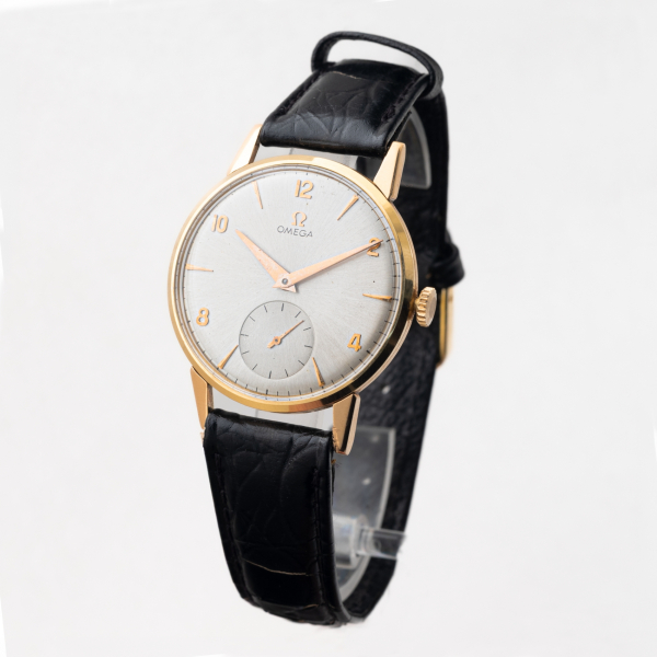 OMEGA. Reloj de pulsera unisex en oro y correa de piel, c.1960.