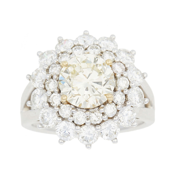 Sortija rosetón en oro blanco con diamantes talla brillante engastados en garras. 