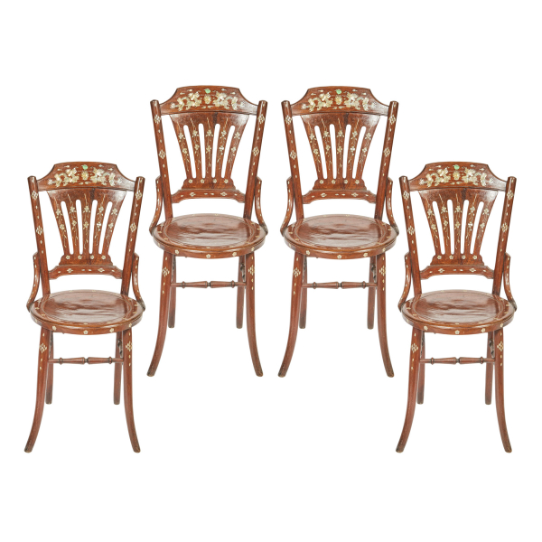 Juego de cuatro sillas orientales en madera frutal tallada con decoración incrustada en nácar de motivos florales y geométricos, s.XX.