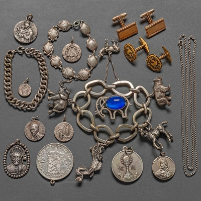 Miscelánea de pulseras con animales, monedas, medallas conmemorativas de la Virgen, gemelos y pulseras en plata.