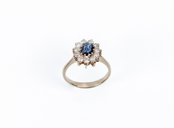 Sortija de oro amarillo en rosetón con centro de zafiro fino azul, oval 